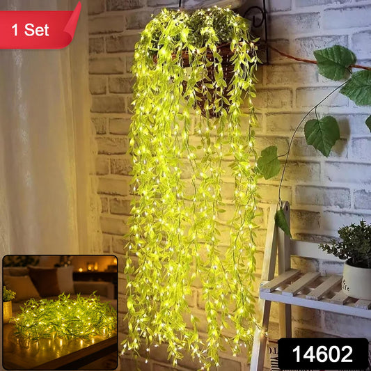 A hanging basket with long strands of green leaf string lights cascading down a brick wall, illuminated, with a red "1 Set"