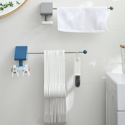 Two wall-mounted racks, one blue and one grey, holding hangers, keys, a brush, and a white towel in a bathroom.