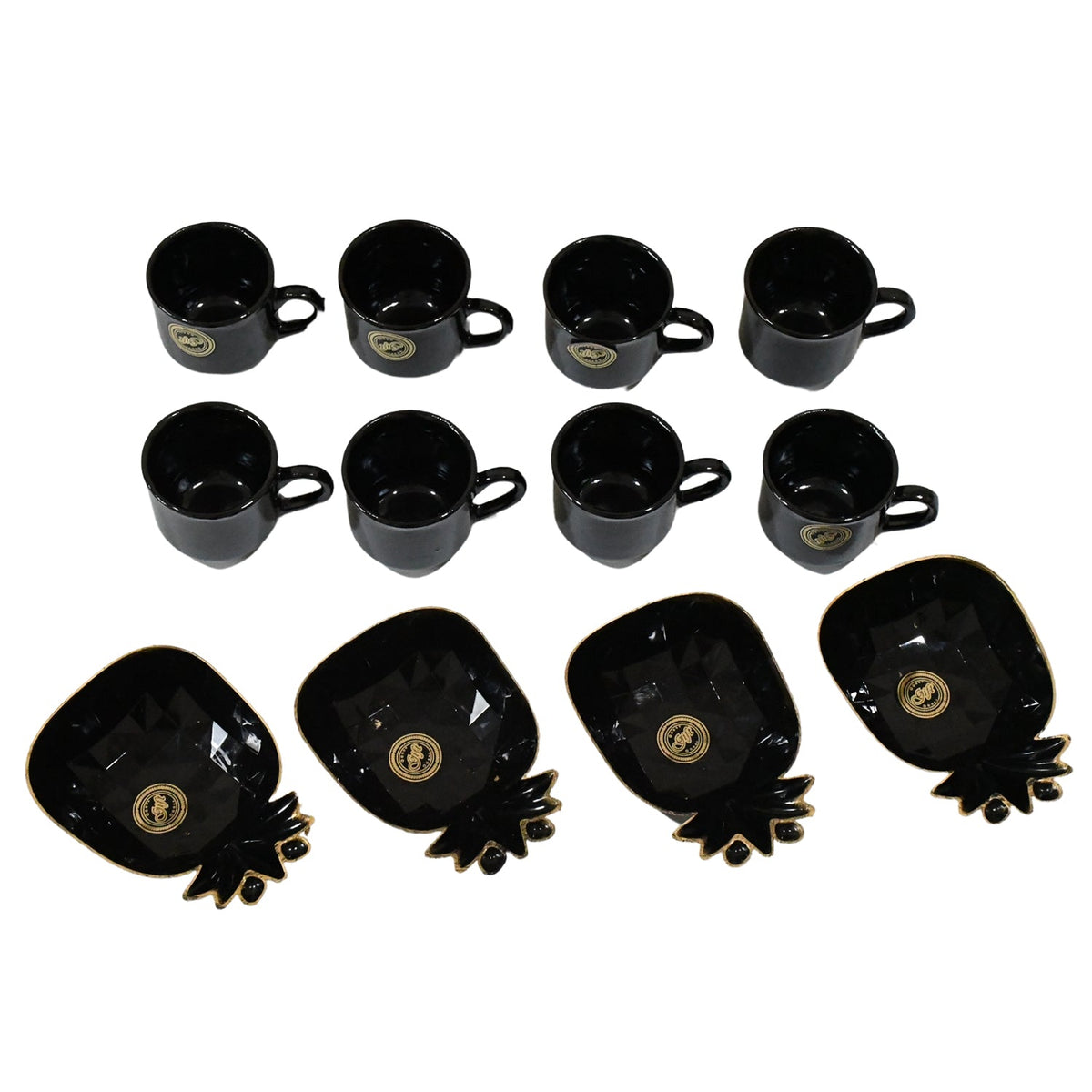A black ceramic tea set with eight cups and four pineapple-shaped snack bowls with gold accents, arranged on a white