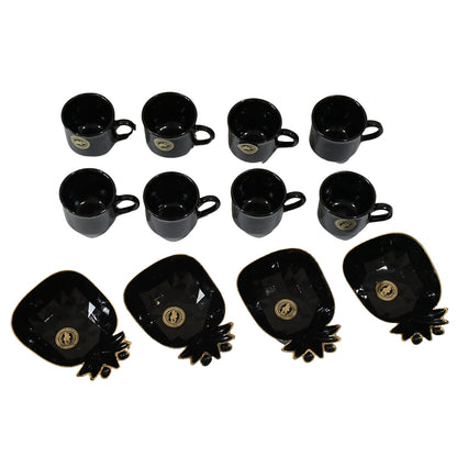 A black ceramic tea set with eight cups and four pineapple-shaped snack bowls with gold accents, arranged on a white