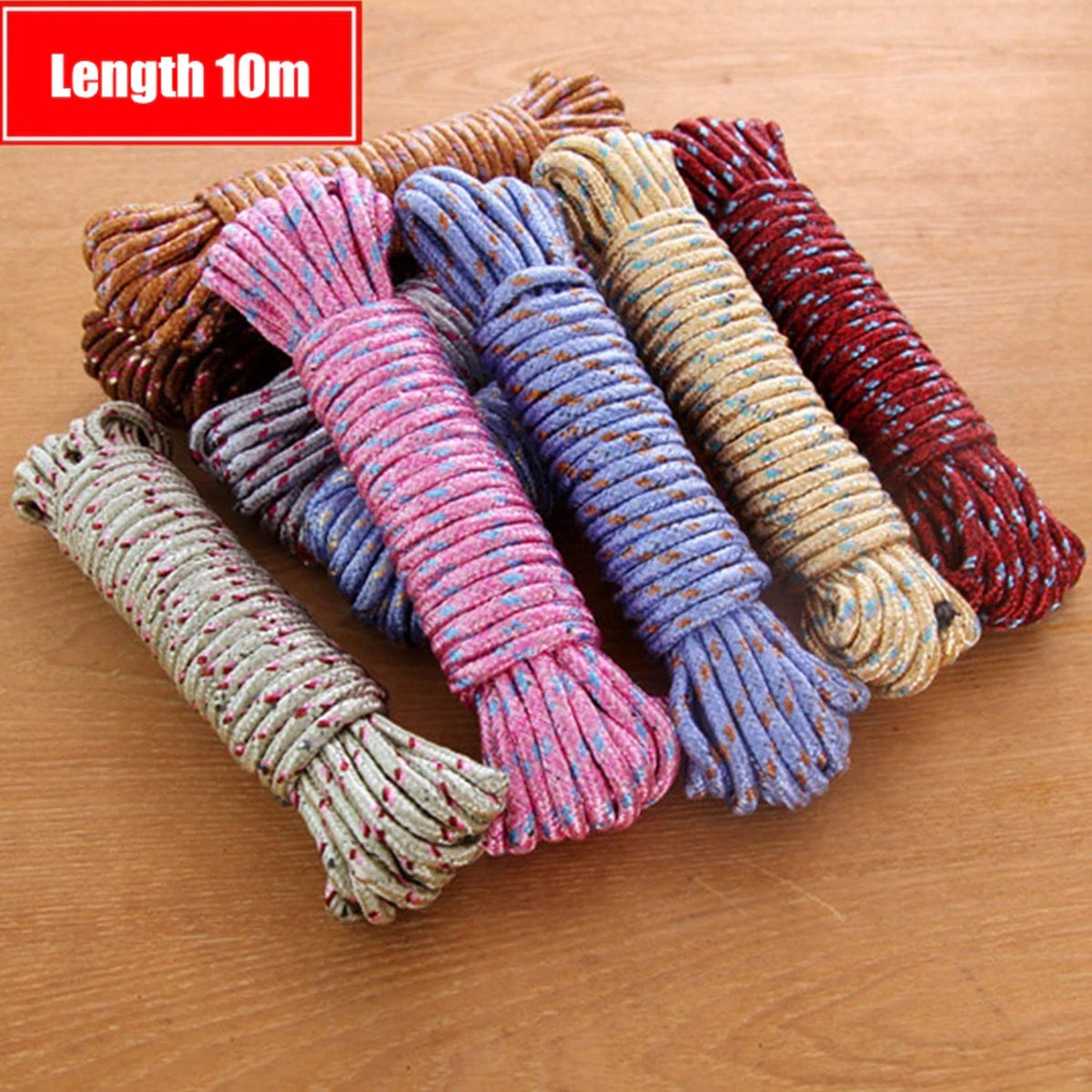 Multiple coiled ropes in various colors, including pink, blue, and brown, arranged on a wooden surface.