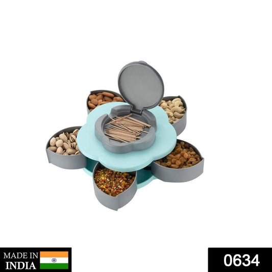 A blue and grey petal-shaped snack dispenser filled with nuts and dried fruit, with 'MADE IN INDIA' and '0634' labels.
