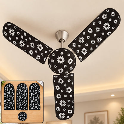 A ceiling fan with black and white floral dust covers installed, with an inset showing the four covers on a wooden surface.