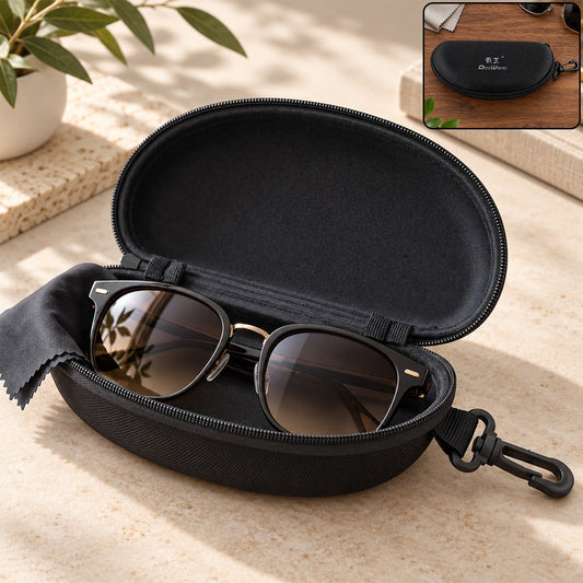 Open black hard shell sunglasses case with black sunglasses and cleaning cloth inside, on a light-colored surface.