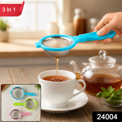 A hand holds a blue tea strainer, pouring tea into a white cup, with a teapot and mint nearby. – view 2