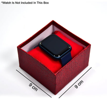 A dark blue smartwatch resting on a red velvet pillow inside an open red textured gift box, with 9 cm dimensions indicated.
