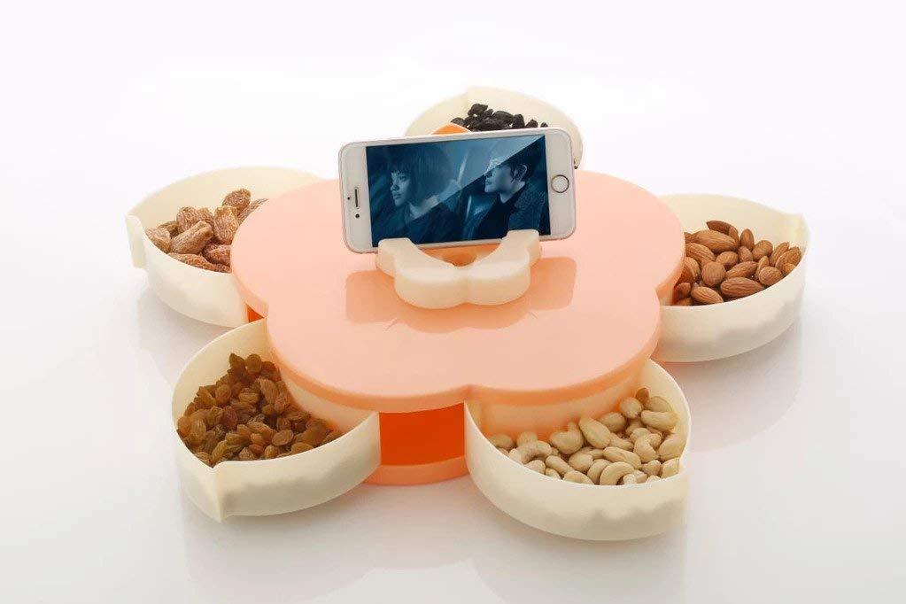 A teal and black petal-shaped storage box is open, revealing its compartments, with a