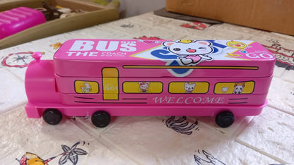 Pink bus pencil case with a cartoon bear on top, resting on a patterned white and brown surface.