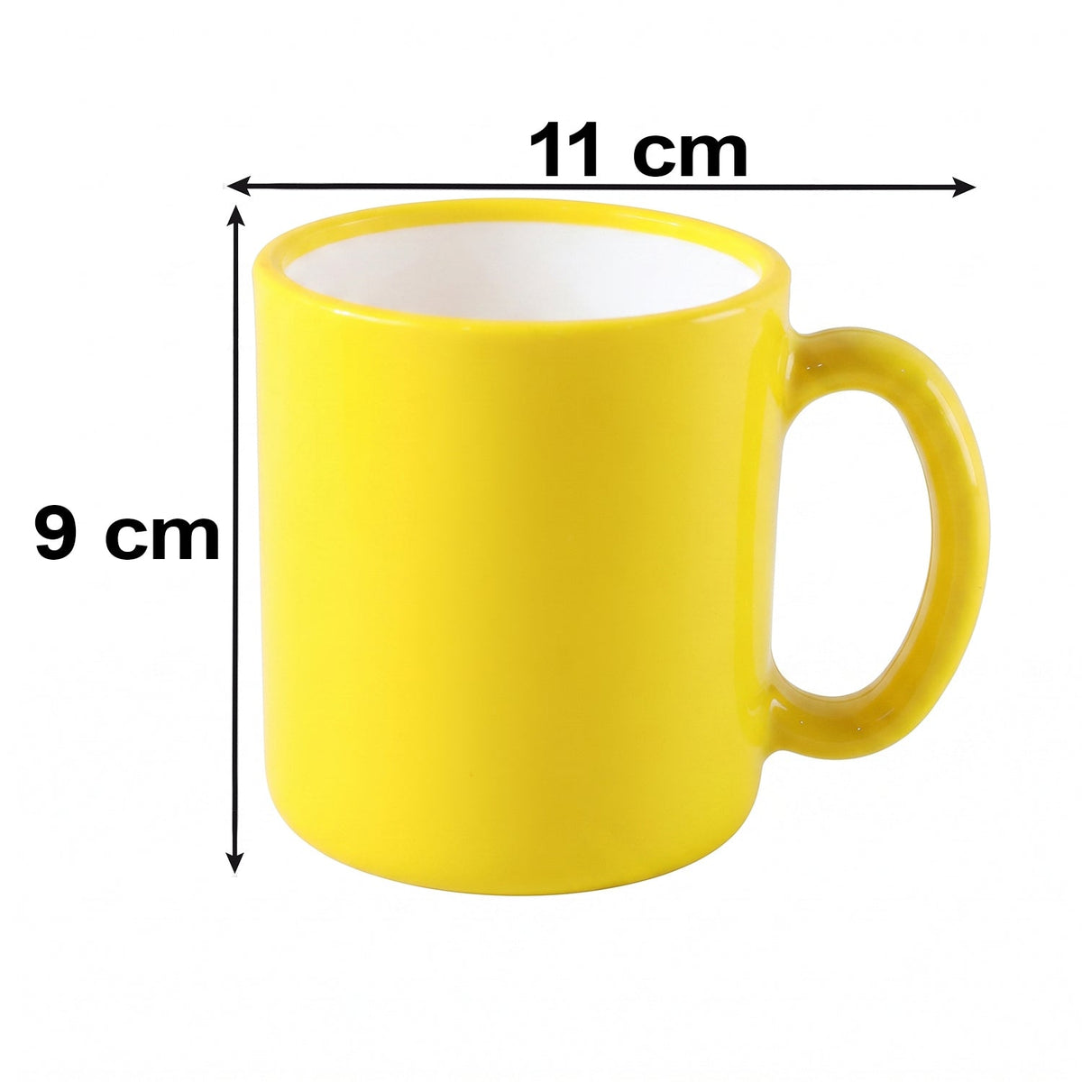 A vibrant yellow mug with a white interior rests on a light-colored, textured surface, with a lemon and books in the