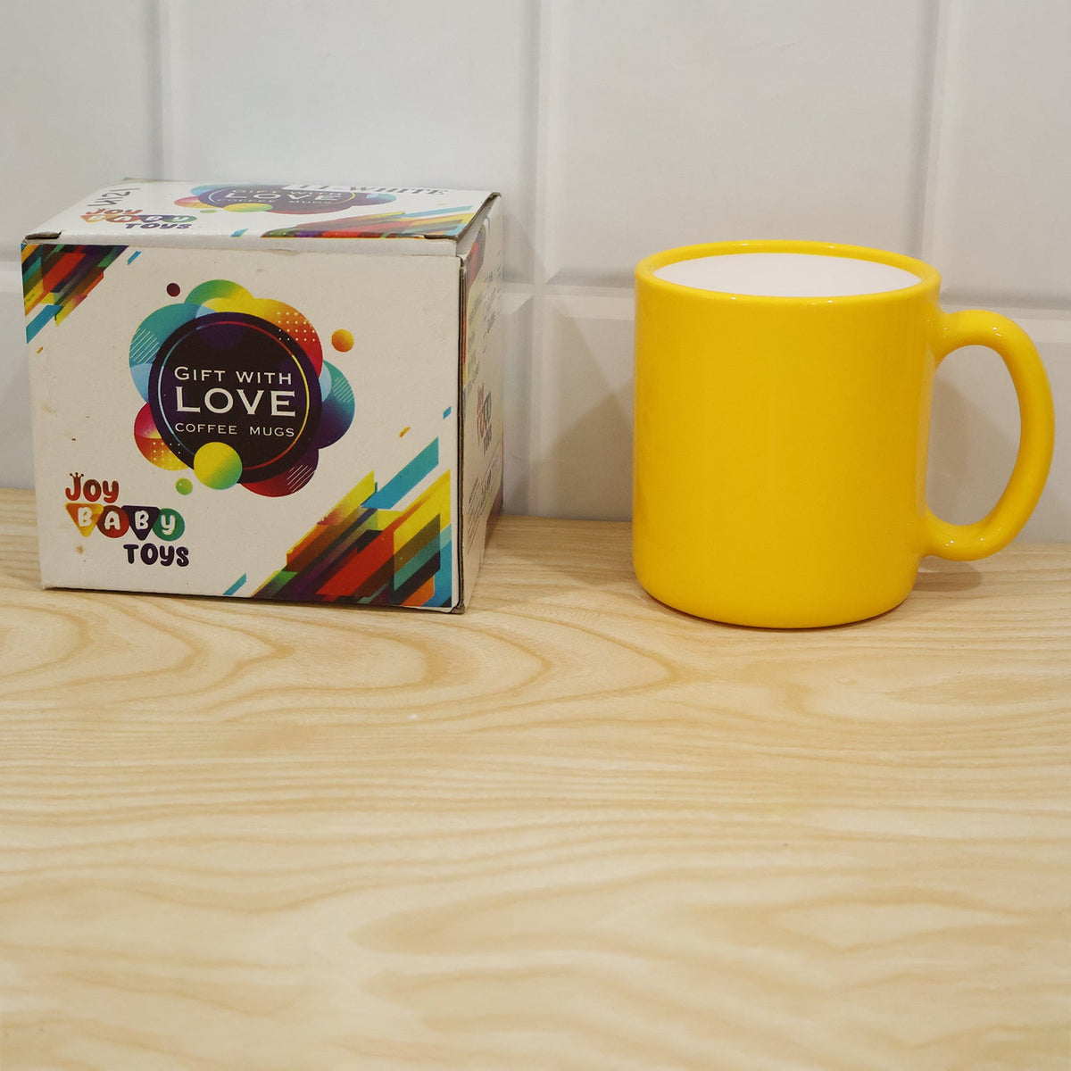 A yellow ceramic mug with a white interior is held by a woman wearing a light-colored knitted sweater.