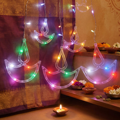 Diya lights decorating a doorway for Diwali