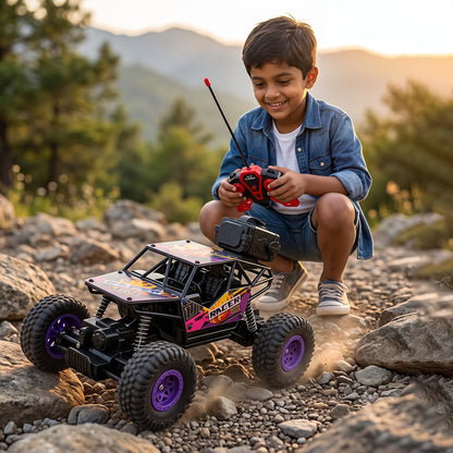 A smiling boy in a denim shirt plays with a black and purple remote control rock crawler with purple wheel hubs on a rocky